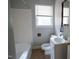 Cozy bathroom featuring a tub with white tiling and a vanity with ample lighting at 2100 Breeze Rd, Raleigh, NC 27608