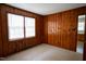 Cozy bedroom with wood paneling and ample natural light at 2100 Breeze Rd, Raleigh, NC 27608