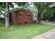 Rear of house showing a brick exterior and a grassy yard, perfect for outdoor activities at 2100 Breeze Rd, Raleigh, NC 27608
