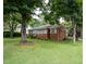 Quaint brick home features lush front yard and ample shade trees at 2100 Breeze Rd, Raleigh, NC 27608