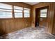 Versatile bonus room with wood paneling, vinyl floors, and windows for natural light at 2100 Breeze Rd, Raleigh, NC 27608