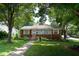 Charming brick home with a well-manicured lawn and mature trees at 2100 Breeze Rd, Raleigh, NC 27608