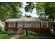 Inviting brick home with landscaped garden and covered front porch at 2100 Breeze Rd, Raleigh, NC 27608