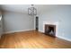 Open living area features hardwood floors and brick fireplace at 2100 Breeze Rd, Raleigh, NC 27608