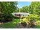 Expansive, beautifully landscaped backyard with lush greenery and mature trees at 211 Hills Of The Haw Rd, Pittsboro, NC 27312