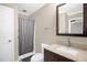 Bathroom featuring a vanity with cultured marble top, a sink, and a walk-in shower at 211 Hills Of The Haw Rd, Pittsboro, NC 27312