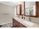 Bathroom featuring a double vanity with cultured marble top, two sinks and a mirror at 211 Hills Of The Haw Rd, Pittsboro, NC 27312