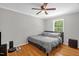 Bedroom featuring hardwood floors, a ceiling fan, and a closet at 211 Hills Of The Haw Rd, Pittsboro, NC 27312