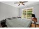 Bedroom with hardwood floors, a ceiling fan and a large window at 211 Hills Of The Haw Rd, Pittsboro, NC 27312