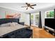 Main bedroom featuring hardwood floors, a ceiling fan, and french doors that lead to the deck at 211 Hills Of The Haw Rd, Pittsboro, NC 27312