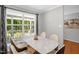 Bright dining area features a modern marble-topped table, hardwood floors, and a large window with scenic views at 211 Hills Of The Haw Rd, Pittsboro, NC 27312