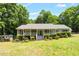 Single-story home with a covered front porch and well-maintained landscaping offers great curb appeal at 211 Hills Of The Haw Rd, Pittsboro, NC 27312