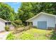 Spacious detached garage with adjacent garden area, perfect for storage and hobbies at 211 Hills Of The Haw Rd, Pittsboro, NC 27312