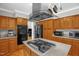 Well-equipped kitchen featuring wooden cabinets, stainless steel appliances, and a functional island with a gas range at 211 Hills Of The Haw Rd, Pittsboro, NC 27312
