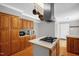 Efficient kitchen features wooden cabinets, stainless steel appliances, and an island, perfect for preparing meals at 211 Hills Of The Haw Rd, Pittsboro, NC 27312