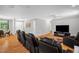 Spacious living room with hardwood floors, ample seating, and plenty of natural light offers an inviting atmosphere at 211 Hills Of The Haw Rd, Pittsboro, NC 27312