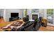 Cozy living room with a fireplace, hardwood floors, and plush seating offers a relaxing retreat at 211 Hills Of The Haw Rd, Pittsboro, NC 27312