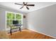 Office featuring hardwood floors, a ceiling fan and a large window at 211 Hills Of The Haw Rd, Pittsboro, NC 27312
