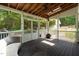 A screened porch featuring wood floors, a ceiling fan, a fireplace and nice outdoor view at 211 Hills Of The Haw Rd, Pittsboro, NC 27312