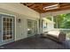 Relaxing screened porch with ceiling fan, wood floors, and cozy seating area at 211 Hills Of The Haw Rd, Pittsboro, NC 27312