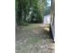 Expansive backyard offers a private retreat with lush trees, perfect for outdoor enjoyment and relaxation at 2116 Tanglewood Rd, Rocky Mount, NC 27804