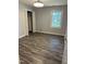 This bedroom features gray walls, hardwood flooring, a window, and a closet at 2116 Tanglewood Rd, Rocky Mount, NC 27804