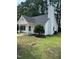 Charming one-story home features a manicured lawn and classic white siding, complemented by a tall chimney at 2116 Tanglewood Rd, Rocky Mount, NC 27804