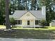 Charming one-story home with a classic white exterior and well-manicured lawn and a gray roof at 2116 Tanglewood Rd, Rocky Mount, NC 27804