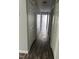 Hallway with hardwood flooring and linen closets provide extra storage space at 2116 Tanglewood Rd, Rocky Mount, NC 27804