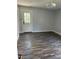 This living room features gray walls, hardwood flooring, and an exterior door with glass panels at 2116 Tanglewood Rd, Rocky Mount, NC 27804