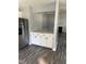 Open-concept space, featuring white cabinets, fireplace, and modern gray flooring at 2116 Tanglewood Rd, Rocky Mount, NC 27804