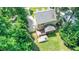 A high aerial view shows the backyard with a firepit, a deck, and mature trees at 212 Heidinger Dr, Cary, NC 27511