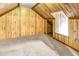 Attic featuring wood paneled walls and a cozy window nook at 212 Heidinger Dr, Cary, NC 27511