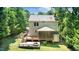 The back exterior features a fire pit, covered deck and steps down to a patio at 212 Heidinger Dr, Cary, NC 27511