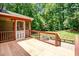 A wooden deck overlooks the backyard with a fire pit and lush greenery, blending indoor and outdoor living at 212 Heidinger Dr, Cary, NC 27511