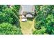 Lush backyard with deck, patio, fire pit, and surrounding greenery at 212 Heidinger Dr, Cary, NC 27511