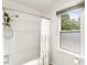 A clean bathroom featuring a shower-tub combo and a bright window, offering a refreshing atmosphere at 212 Heidinger Dr, Cary, NC 27511
