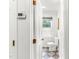 A peek inside the bathroom showcasing a toilet and black and white checkered flooring at 212 Heidinger Dr, Cary, NC 27511