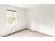 Cozy bedroom with neutral carpet, a bright window, and clean white walls at 212 Heidinger Dr, Cary, NC 27511