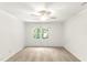 Clean, carpeted bedroom with a ceiling fan and bright window overlooking lush greenery at 212 Heidinger Dr, Cary, NC 27511