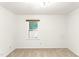 An empty bedroom with neutral carpet, a window, and a simple lighting fixture at 212 Heidinger Dr, Cary, NC 27511