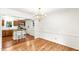 Open dining room with views of the eat-in kitchen, hardwood floors, and gold chandelier at 212 Heidinger Dr, Cary, NC 27511