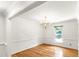 Empty, bright dining room with hardwood floors and simple chandelier at 212 Heidinger Dr, Cary, NC 27511