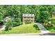 Traditional brick home with a well-manicured lawn and mature trees at 212 Heidinger Dr, Cary, NC 27511