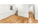 Entry hallway featuring hardwood floors, access to stairs, and a view into other rooms at 212 Heidinger Dr, Cary, NC 27511