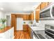 Kitchen featuring wood cabinets, stainless steel appliances, and white countertops at 212 Heidinger Dr, Cary, NC 27511
