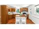 Eat-in kitchen featuring an island, stainless steel appliances, wood cabinets, and white countertops at 212 Heidinger Dr, Cary, NC 27511