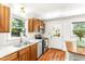 Bright kitchen featuring stainless steel appliances, wood cabinets, white countertops, and a view to the outside at 212 Heidinger Dr, Cary, NC 27511