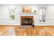 Bright living room with a brick fireplace, hardwood floors, and large windows at 212 Heidinger Dr, Cary, NC 27511