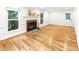 Open living room featuring hardwood floors, fireplace, and bright windows at 212 Heidinger Dr, Cary, NC 27511